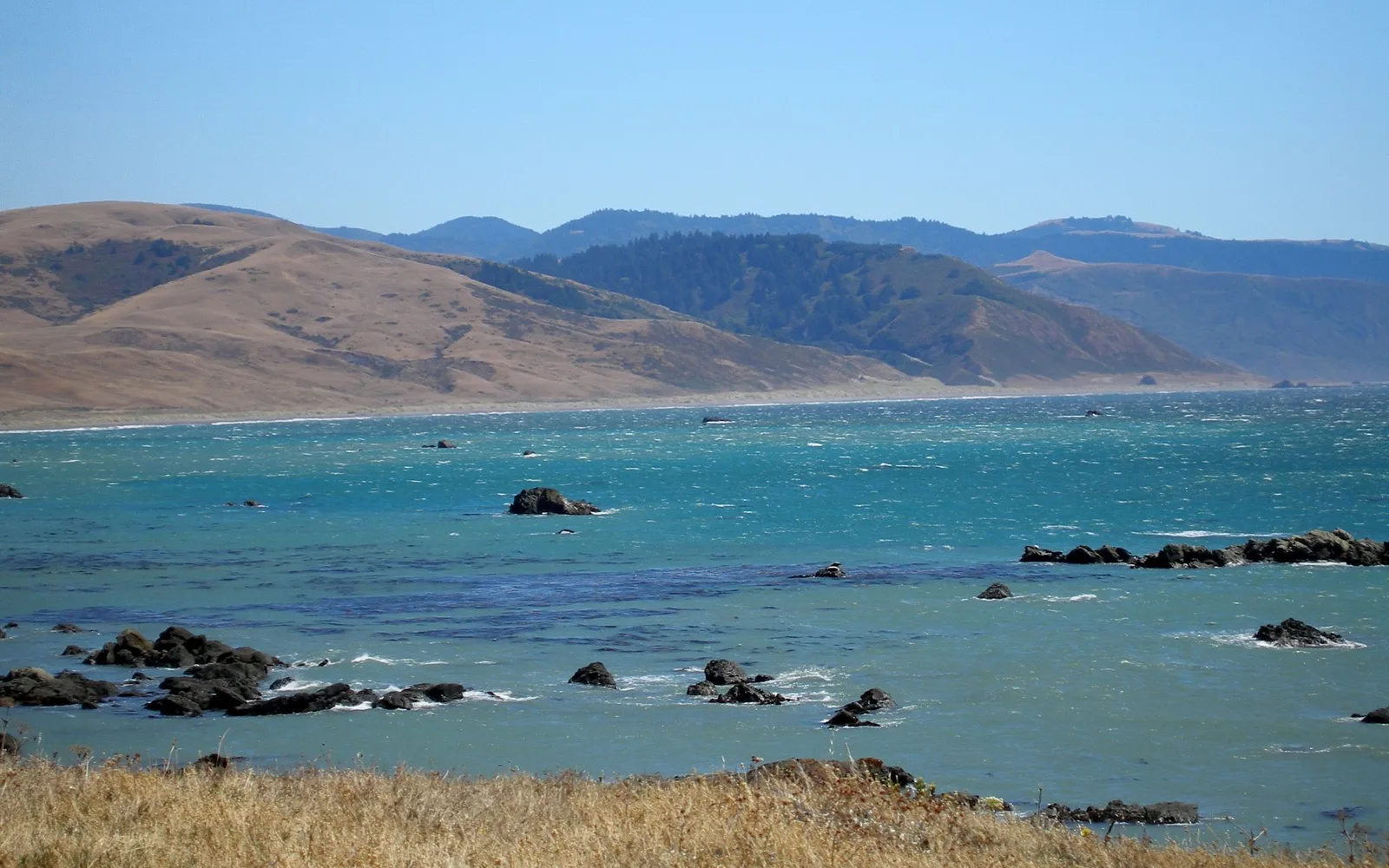Dramatic coastal seascape showing rugged ocean bluffs and crashing waves along the California North Coast